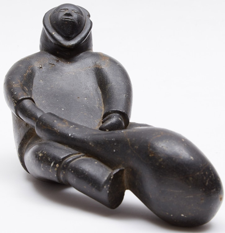 Artwork by Noah Qinuajua, Sitting Figure with a Seal Float