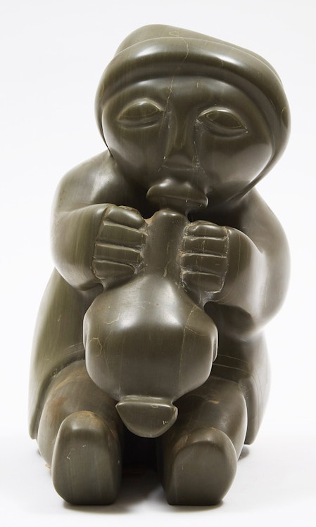 Artwork by Unidentified Inuit Artist (Sanikiluaq), Woman Blowing up a Sealskin Float